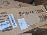 a cardboard box with a barcode on it sitting on top of a pile of boxes
