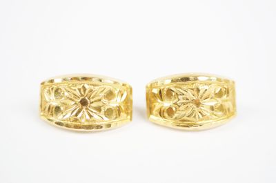 a pair of yellow gold cufflinks with floral design