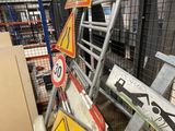 a pile of signs and other signs in a warehouse