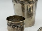 three silver cups sitting next to each other on a table