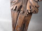 carved wood sculpture of a leaf on a white background