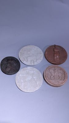 quatre types de pièces différents posés sur une table avec un fond blanc