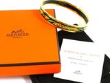an orange box with a ring on top of it next to a black box