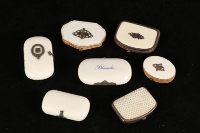 a group of small white and black objects on a black surface