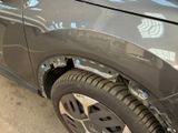 a close up of a car that has a dent in it