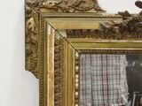 a reflection of a man in a mirror on the wall
