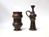 two vases sitting next to each other on a white surface