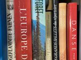 many books that are on a shelf in a box