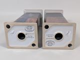 pair of two speakers sitting side by side on a white surface