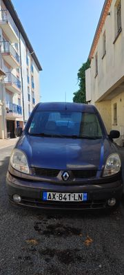 une petite voiture bleue garée sur le bord de la route