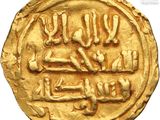 a close up of a gold coin with arabic writing on it