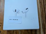 an apple airpods are sitting on top of a box on a wooden table
