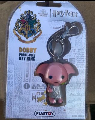 a pink pig keychain with a harry potter logo on it