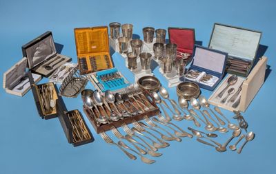 a lot of silverware on a blue surface