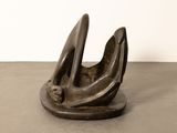 an image of a bronze sculpture of a bird on a table