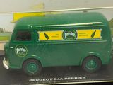 a green toy bus that is on display in a glass case