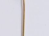 an image of a gold brooch with a pearl in the center