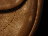 a close up of a brown leather purse with a chain on it