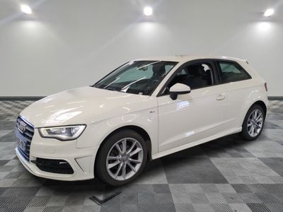 a white audi is parked in a room with a checkered floor
