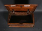 an old wooden box with a key in it sitting on a table