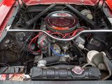 a red car with an engine in the trunk of it