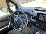dashboard view of a car with a steering wheel and dashboard controls