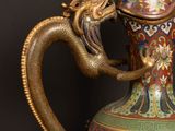 a vase that has a dragon on it and a dragon on it