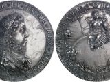 two silver coins with a portrait of a man and a woman on them