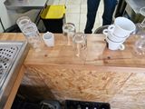 many cups and glasses on the counter in the kitchen