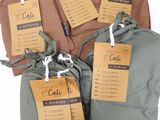 three bags with tags on them are sitting on a table