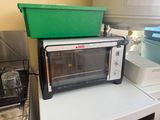 a toaster oven sitting on top of a washing machine