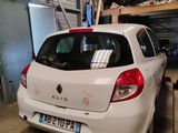 a small white car parked in a garage