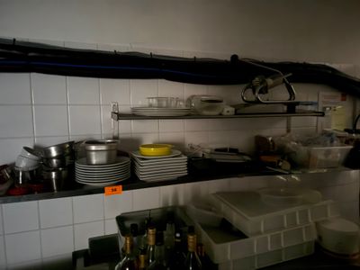 a kitchen with a lot of dishes and dishes on the counter