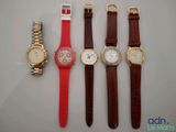 four different types of watches are lined up on a table