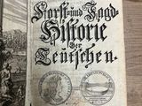 an old book that is open on a table