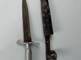 two knives that are sitting next to each other on a table
