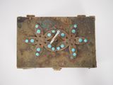 an image of a close up of a metal object with turquoise stones