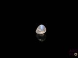 a close up of a white stone on a black surface