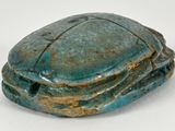 a blue and green stone object on a white surface