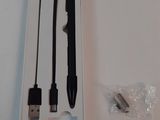 a white box with a black pen and a usb cable in it