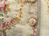 a close up of a dress with buttons on it