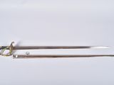 a pair of swords on a white surface with a gold handle