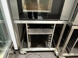 a man taking a picture of himself in the mirror of an oven