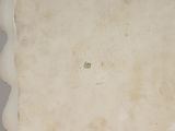 a white plate with a flower on it on a table