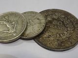 three coins sitting on top of each other on top of a table