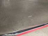 a close up of a car ' s bumper with a red strip