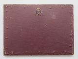 a close up of a piece of red paper on a white surface