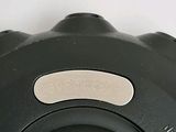 a close up of a black object on a white surface