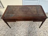 an old wooden desk with a drawer on top of it