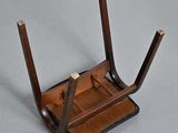 a small wooden desk with a leather case on it